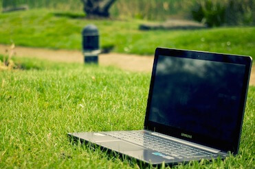 Working outside laptop on the lawn