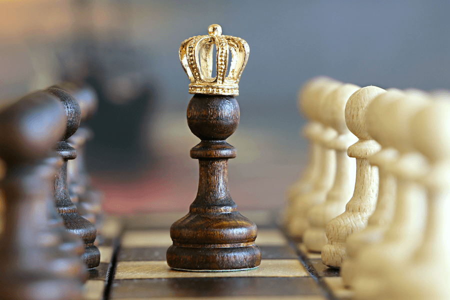 Pawn chess piece wearing crown